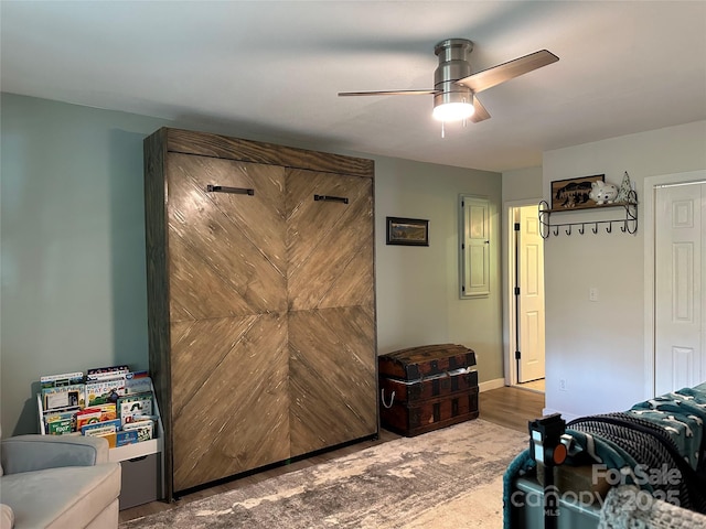 bedroom with baseboards, a ceiling fan, and wood finished floors