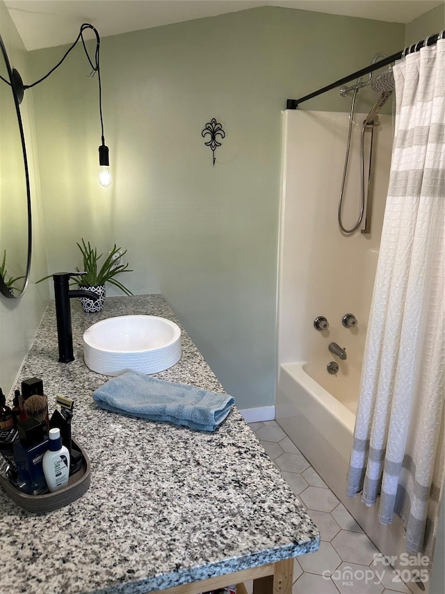 full bathroom featuring tile patterned floors, baseboards, shower / bath combo, and vanity