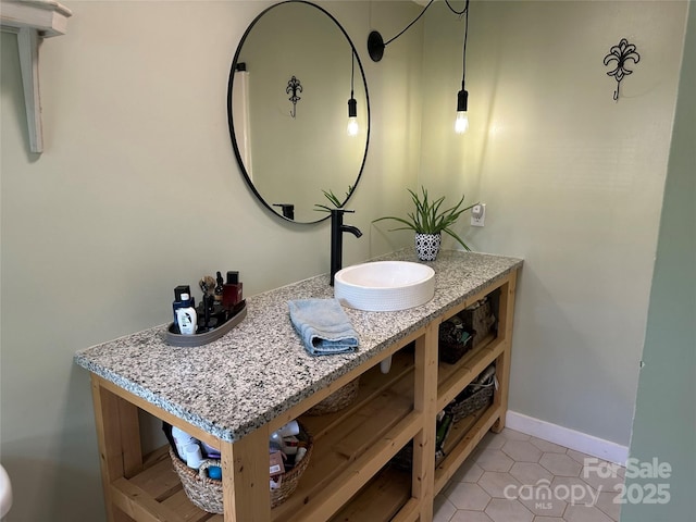 bathroom featuring vanity, baseboards, and tile patterned flooring
