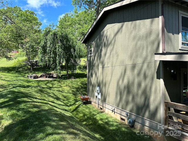 view of side of home with a lawn