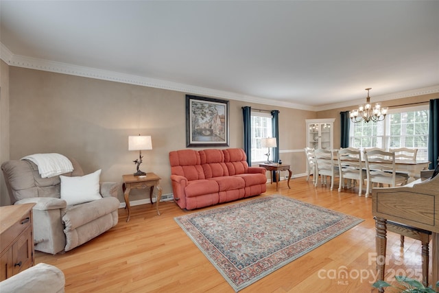 8525 Castlekeep Rd Unit 26, Charlotte, NC 28226 - living area with a chandelier, light wood-style flooring, plenty of natural light, crown molding, and baseboards