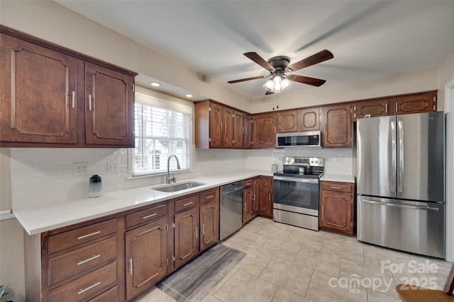 8525 Castlekeep Rd Unit 26, Charlotte, NC 28226 - kitchen featuring appliances with stainless steel finishes, a sink, backsplash, a ceiling fan, and light countertops