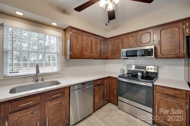 8525 Castlekeep Rd Unit 26, Charlotte, NC 28226 - kitchen with appliances with stainless steel finishes, a sink, ceiling fan, light tile patterned floors, and light countertops