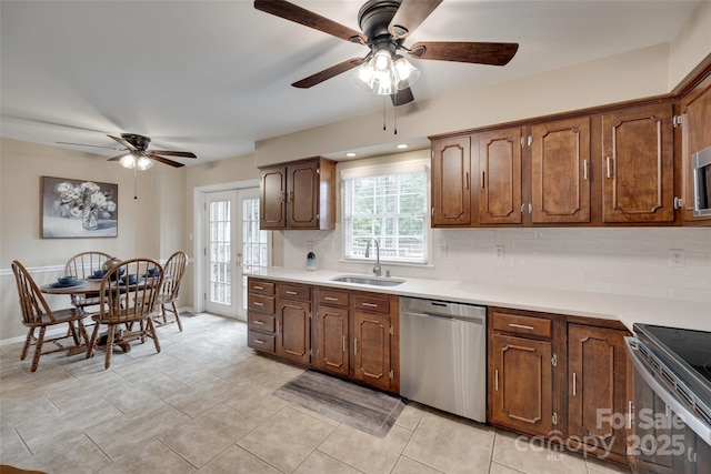 8525 Castlekeep Rd Unit 26, Charlotte, NC 28226 - kitchen with appliances with stainless steel finishes, a sink, a ceiling fan, tasteful backsplash, and light countertops