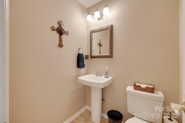 8525 Castlekeep Rd Unit 26, Charlotte, NC 28226 - half bath featuring toilet, tile patterned floors, baseboards, and a sink