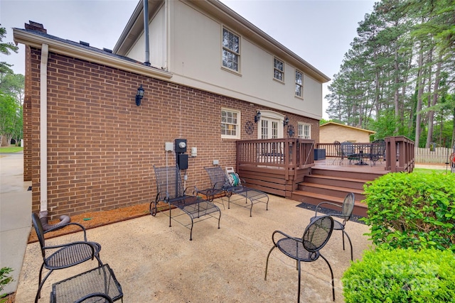 8525 Castlekeep Rd Unit 26, Charlotte, NC 28226 - back of house featuring brick siding, a deck, a patio, a chimney, and stucco siding