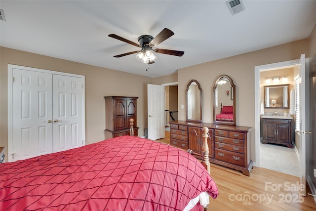 8525 Castlekeep Rd Unit 26, Charlotte, NC 28226 - bedroom with a closet, light wood-style flooring, a sink, a ceiling fan, and ensuite bath