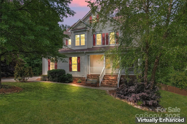 view of front of house with fence, a yard, and a porch
