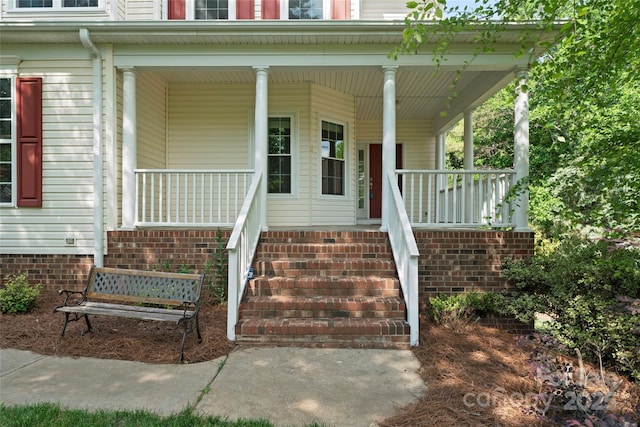 doorway to property featuring covered porch