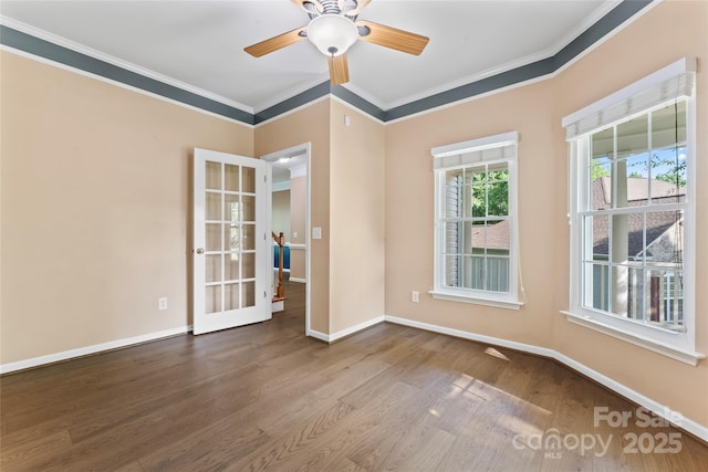 unfurnished room with crown molding, baseboards, ceiling fan, and wood finished floors