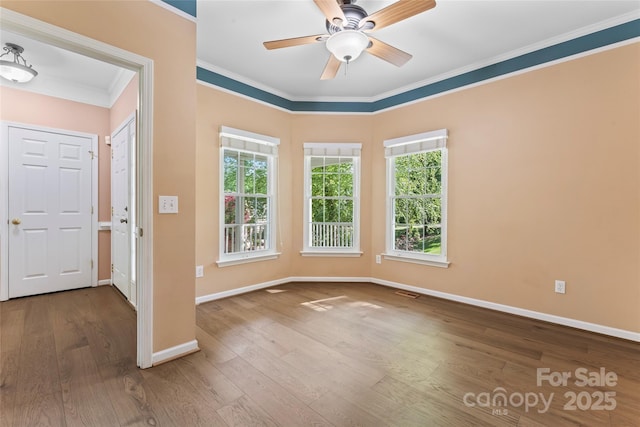 foyer featuring ornamental molding, a healthy amount of sunlight, and hardwood / wood-style flooring
