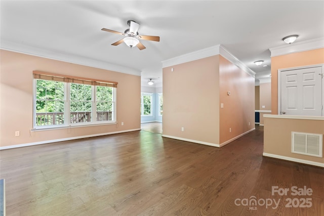 unfurnished living room featuring ceiling fan, visible vents, wood finished floors, baseboards, and ornamental molding