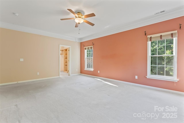 empty room featuring crown molding, ceiling fan, plenty of natural light, and baseboards