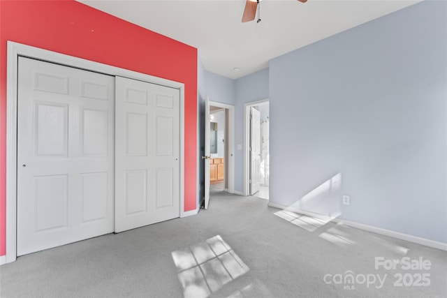 unfurnished bedroom featuring carpet floors, a ceiling fan, baseboards, and a closet