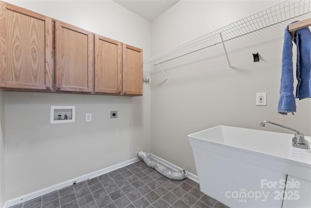 washroom featuring cabinet space, a sink, hookup for a washing machine, baseboards, and hookup for an electric dryer