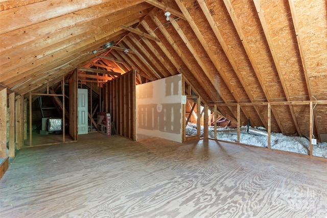 unfinished attic featuring an upstairs landing