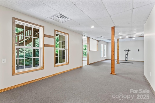 basement with visible vents, baseboards, and carpet floors