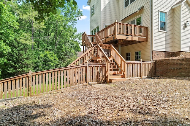 back of house with stairway, fence, and a wooden deck