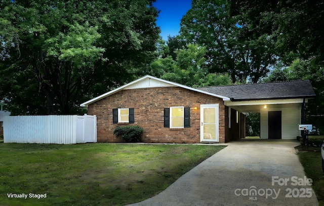 single story home with brick siding, fence, a front yard, and concrete driveway