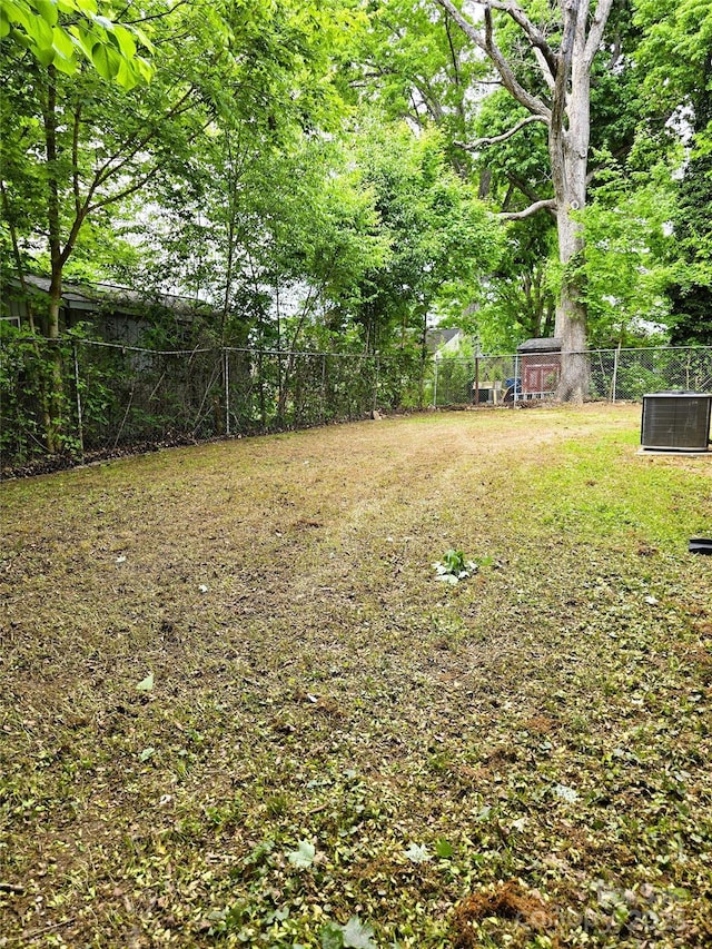 view of yard with fence and cooling unit