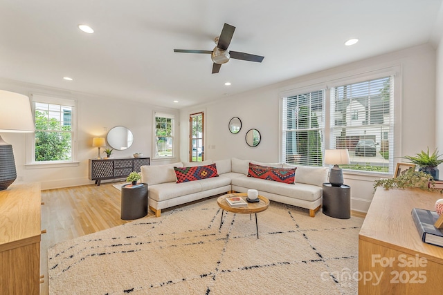 living room with recessed lighting, ceiling fan, a wealth of natural light, and wood finished floors