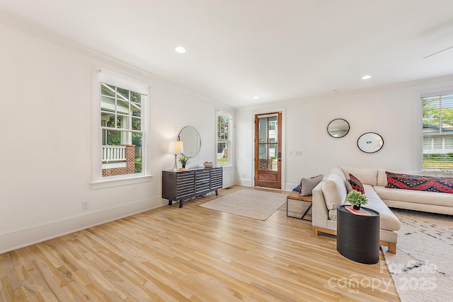 living area featuring baseboards, recessed lighting, and wood finished floors