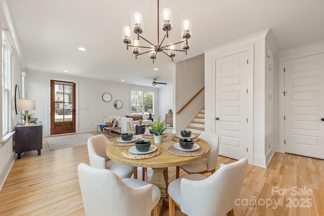 dining area with stairs, baseboards, an inviting chandelier, recessed lighting, and light wood-style flooring