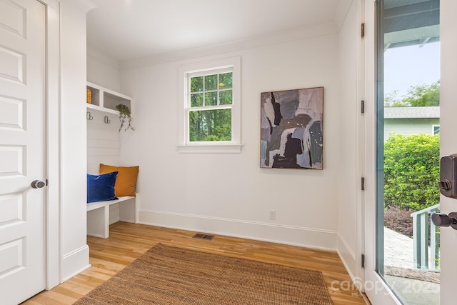 mudroom with light wood-type flooring, baseboards, and visible vents