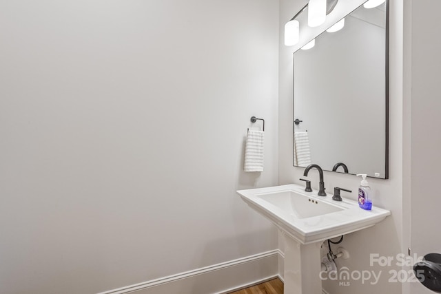 bathroom featuring baseboards and wood finished floors