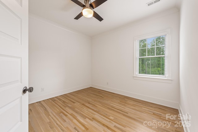 unfurnished room with visible vents, a ceiling fan, light wood-style floors, and baseboards