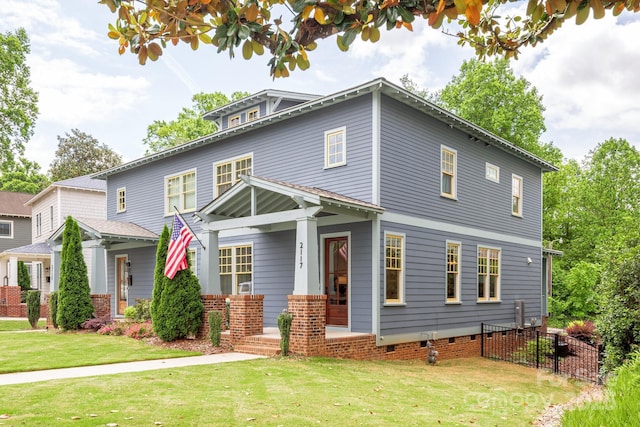 traditional style home featuring covered porch and a front lawn