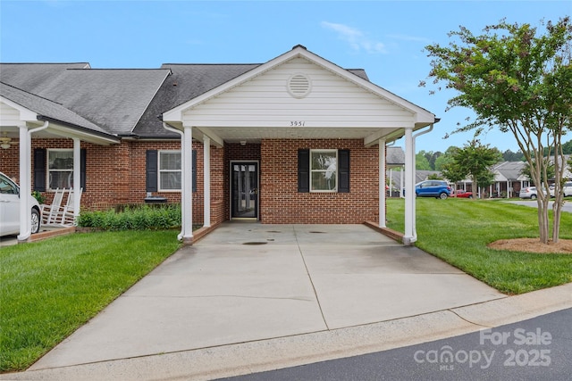 ranch-style home featuring a front yard, driveway, and brick siding