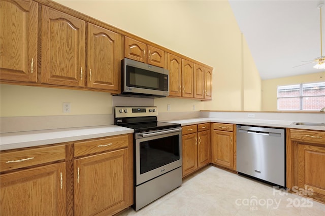 kitchen featuring brown cabinetry, a sink, and appliances with stainless steel finishes