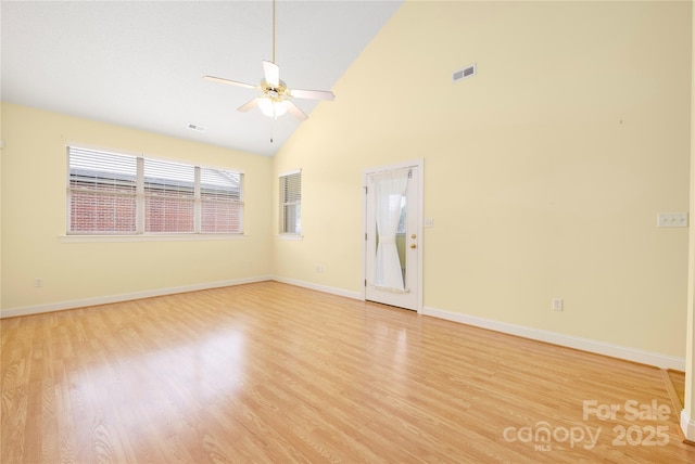 spare room with visible vents, a ceiling fan, light wood-style floors, and high vaulted ceiling