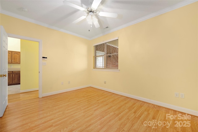 empty room with crown molding, a ceiling fan, baseboards, and light wood-style flooring