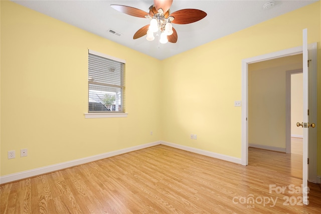 unfurnished room featuring visible vents, baseboards, ceiling fan, and wood finished floors