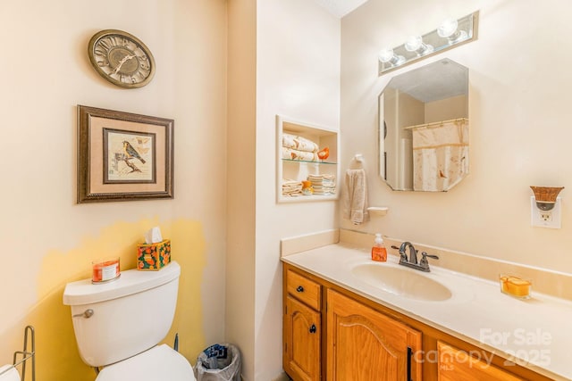 bathroom featuring toilet and vanity