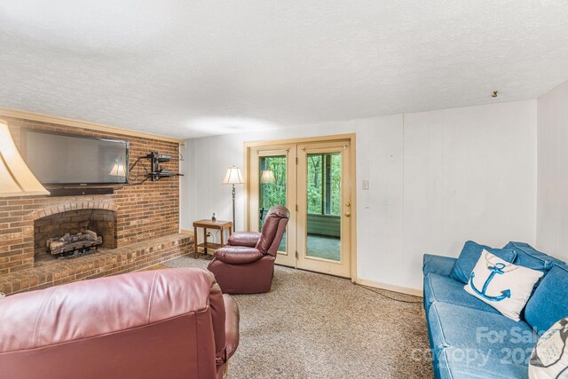 living area with a textured ceiling, carpet, and baseboards