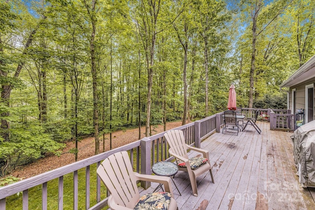 wooden terrace featuring outdoor dining area