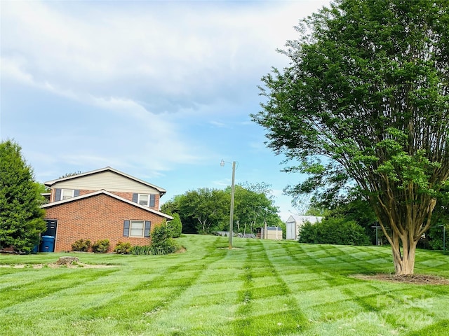 view of yard with an outdoor structure and a shed