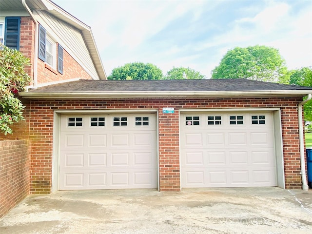 garage featuring concrete driveway