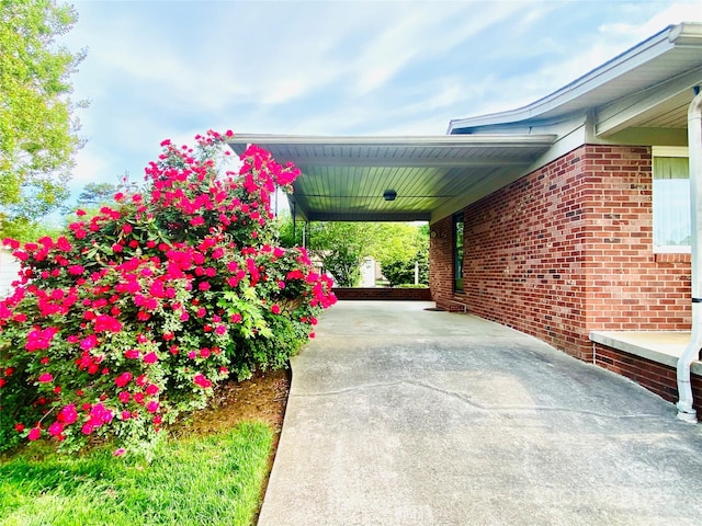 view of patio / terrace with concrete driveway and an attached carport