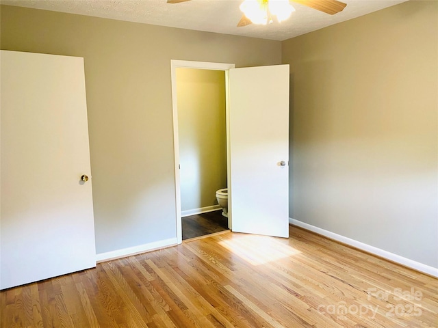 unfurnished bedroom with baseboards, ceiling fan, and wood finished floors