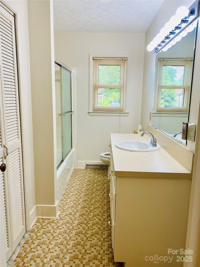 full bath with plenty of natural light, baseboards, tile patterned floors, and vanity