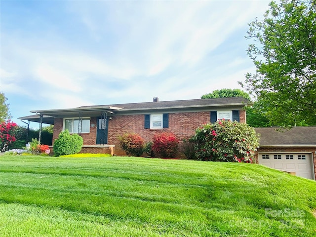 ranch-style house with brick siding, an attached garage, and a front lawn