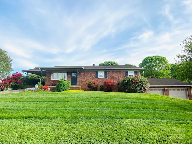 ranch-style home with a garage, brick siding, a front lawn, concrete driveway, and an attached carport