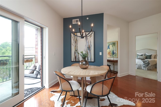 721 Governor Morrison St Unit 520, Charlotte, NC 28211 - dining room with a chandelier, wood finished floors, and baseboards