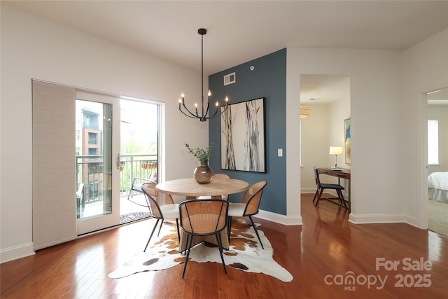 721 Governor Morrison St Unit 520, Charlotte, NC 28211 - dining area featuring wood finished floors, a chandelier, and baseboards