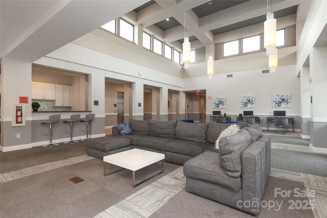 721 Governor Morrison St Unit 520, Charlotte, NC 28211 - living area featuring carpet, a high ceiling, coffered ceiling, beam ceiling, and baseboards