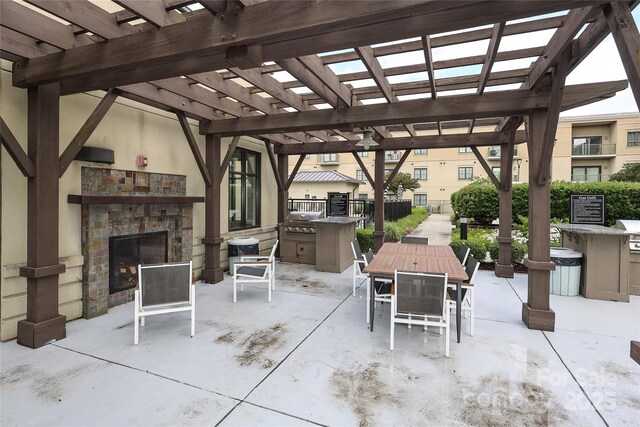 721 Governor Morrison St Unit 520, Charlotte, NC 28211 - view of patio / terrace with an outdoor stone fireplace, exterior kitchen, a pergola, and outdoor dining area